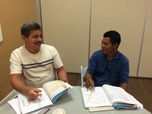 HCC students, Silvino and Edgar review their work during break.